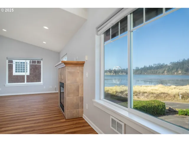 a kitchen with stainless steel appliances granite countertop a stove top oven a sink dishwasher and a refrigerator