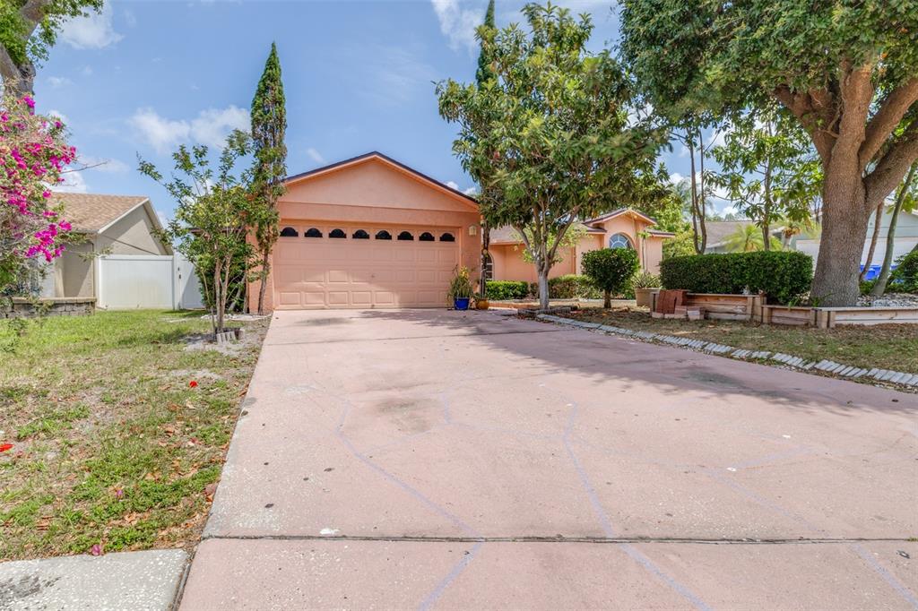 2538 Countryside Pines Drive Clearwater, FL 33761 - Photo 1 of 61 a front view of a house with a yard and garage