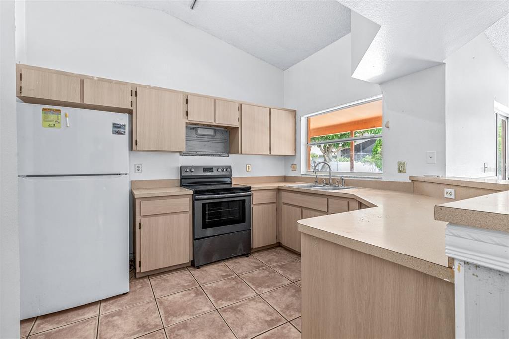 2538 Countryside Pines Drive Clearwater, FL 33761 - Photo 16 of 61 a kitchen with a refrigerator sink and stove