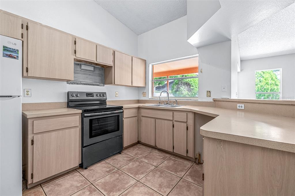 2538 Countryside Pines Drive Clearwater, FL 33761 - Photo 17 of 61 a kitchen with a sink stove and microwave