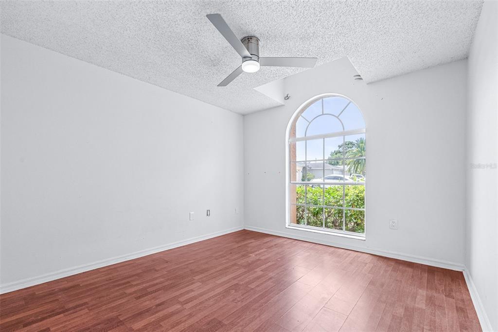 2538 Countryside Pines Drive Clearwater, FL 33761 - Photo 27 of 61 an empty room with wooden floor fan and windows