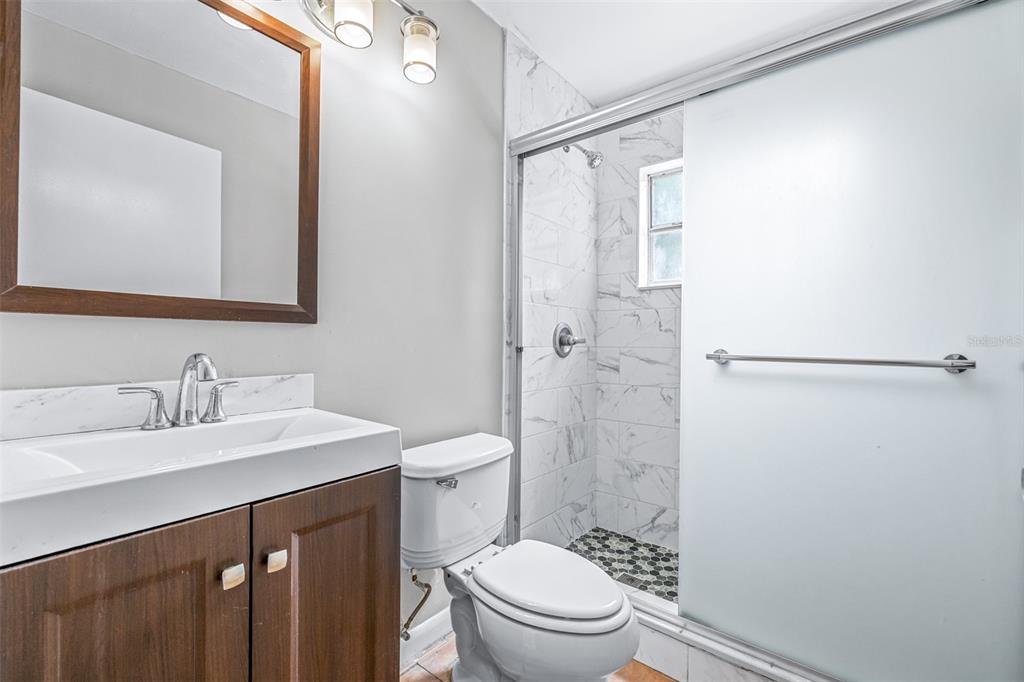 2538 Countryside Pines Drive Clearwater, FL 33761 - Photo 29 of 61 a bathroom with a sink a toilet and shower