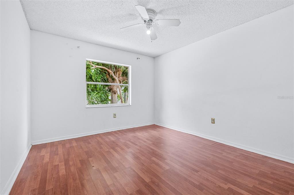 2538 Countryside Pines Drive Clearwater, FL 33761 - Photo 30 of 61 an empty room with wooden floor and windows