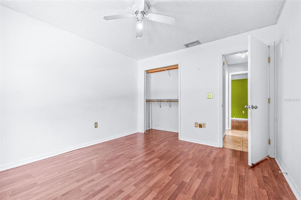 2538 Countryside Pines Drive Clearwater, FL 33761 - Photo 32 of 61 an empty room with wooden floor and a ceiling fan