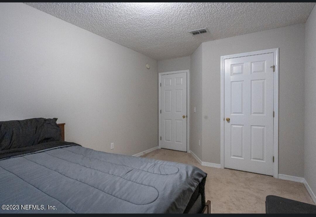 2504 Mallory Hills Road Jacksonville, FL 32221 - Photo 20 of 30 a bedroom with a bed and a window