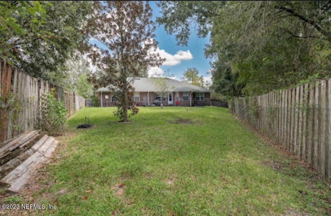 2504 Mallory Hills Road Jacksonville, FL 32221 - Photo 28 of 30 a view of a yard with a house and large trees