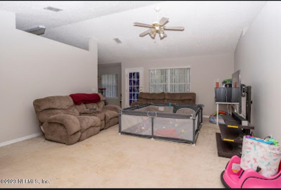 2504 Mallory Hills Road Jacksonville, FL 32221 - Photo 3 of 30 a living room with furniture and a flat screen tv