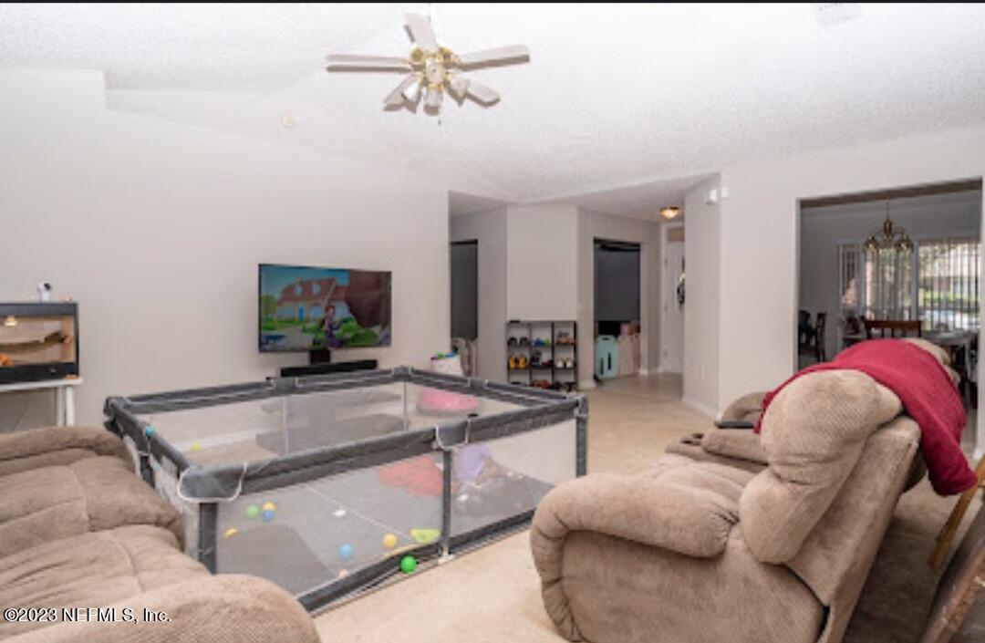 2504 Mallory Hills Road Jacksonville, FL 32221 - Photo 4 of 30 a living room with furniture and a flat screen tv