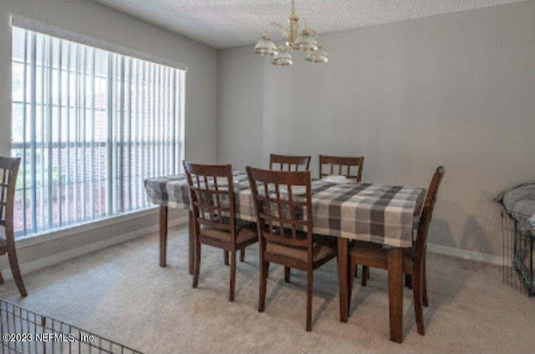2504 Mallory Hills Road Jacksonville, FL 32221 - Photo 6 of 30 a view of a dining room with furniture and chandelier