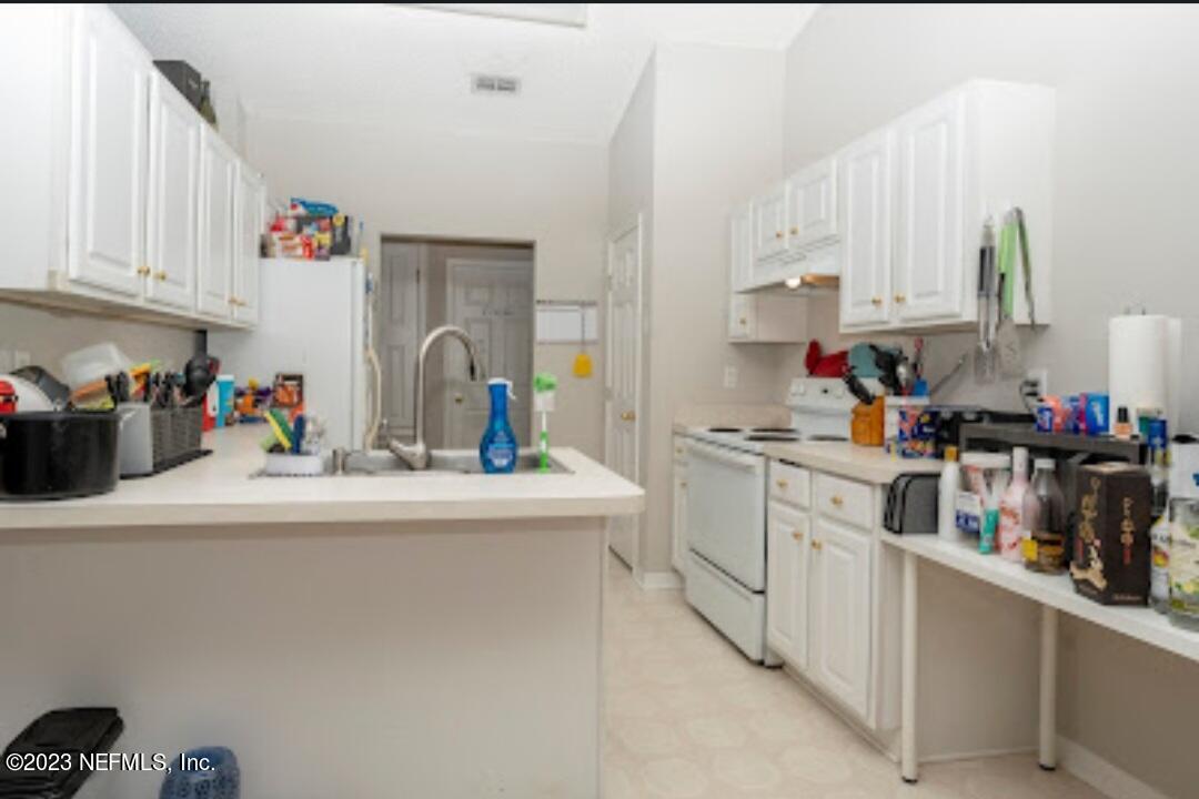 2504 Mallory Hills Road Jacksonville, FL 32221 - Photo 8 of 30 a kitchen with stainless steel appliances granite countertop a sink dishwasher and cabinets with wooden floor
