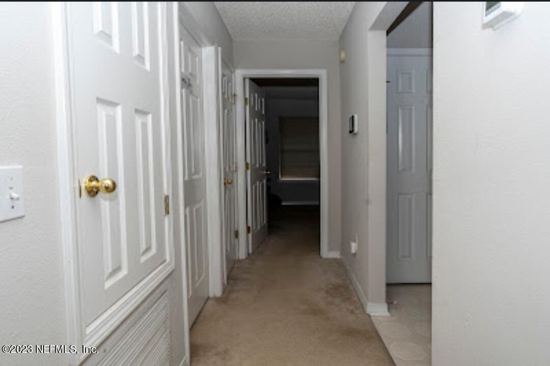 2504 Mallory Hills Road Jacksonville, FL 32221 - Photo 10 of 30 a view of a hallway with a wooden cabinets