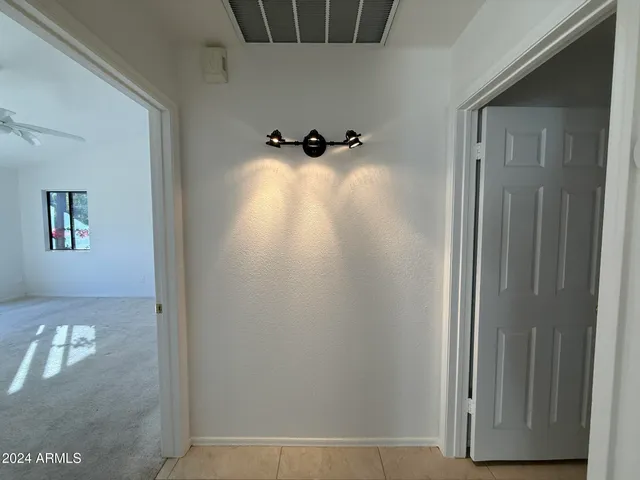 an empty room with windows and closet