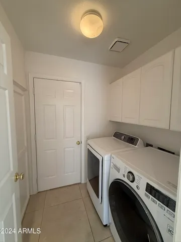 a view of a hallway with wooden floor and a bathroom