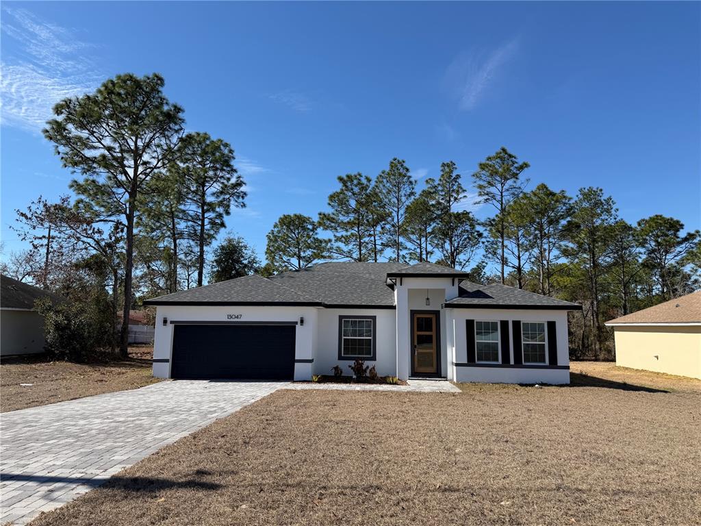13047 Southwest 79th Circle Ocala, FL 34473 - Photo 1 of 1 a front view of a house with a yard and garage