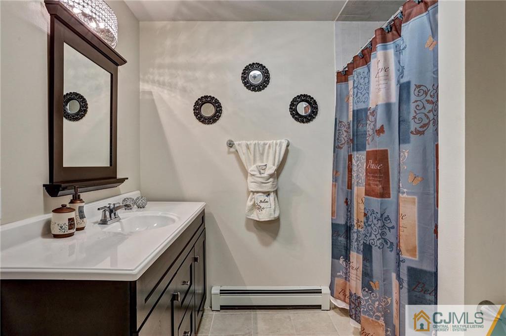 26 Pleasant Valley Road Old Bridge, NJ 08857 - Photo 14 of 25 a bathroom with a sink vanity and mirror