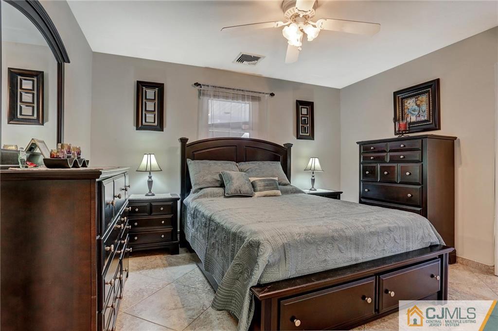 26 Pleasant Valley Road Old Bridge, NJ 08857 - Photo 15 of 25 a bedroom with a bed and a chandelier