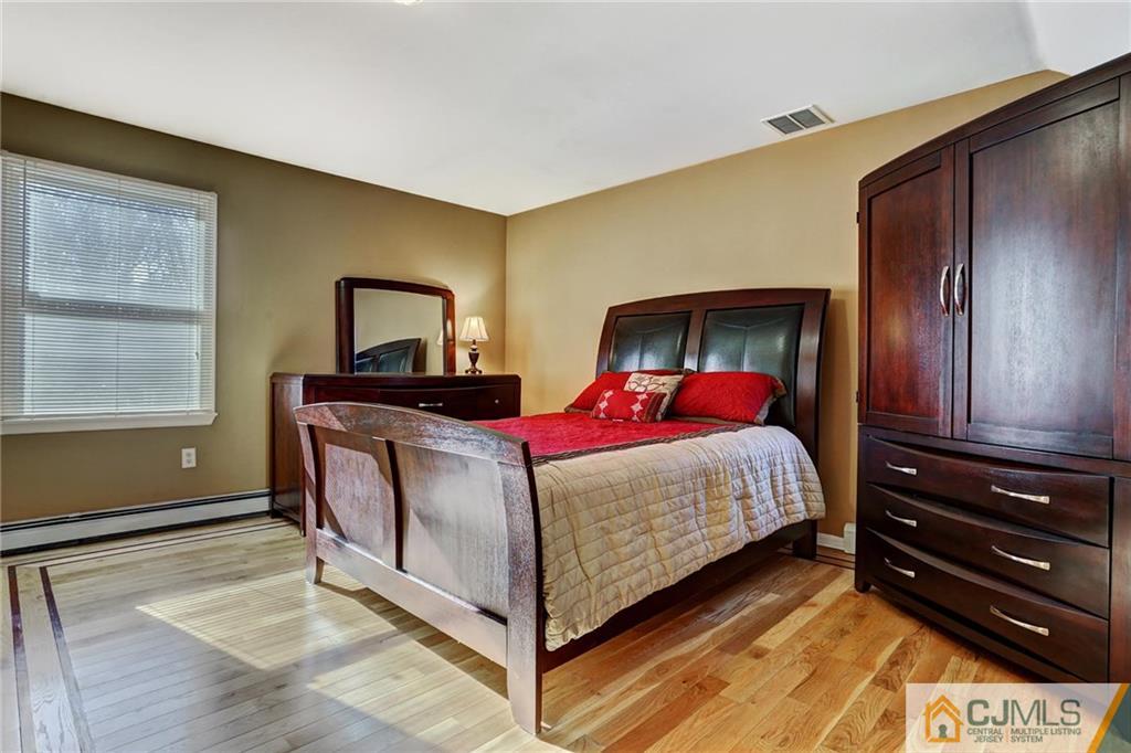 26 Pleasant Valley Road Old Bridge, NJ 08857 - Photo 16 of 25 a bed sitting in a bedroom next to a window