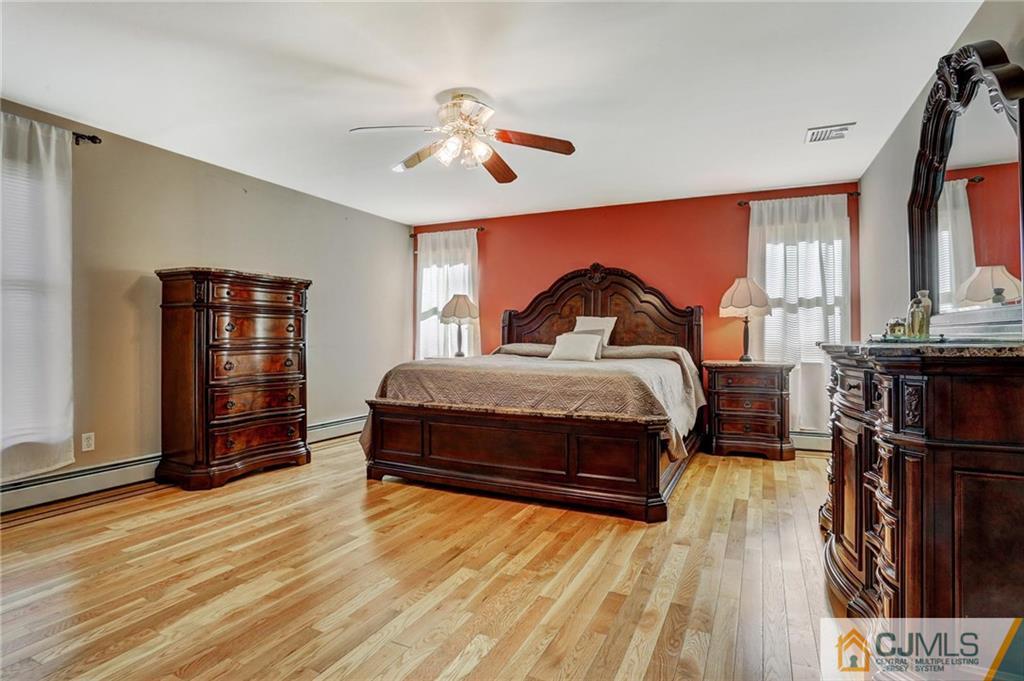 26 Pleasant Valley Road Old Bridge, NJ 08857 - Photo 18 of 25 a bedroom with a bed and wooden floor
