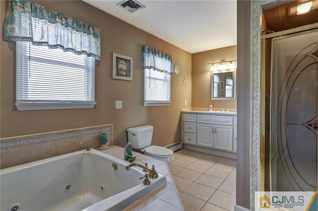 26 Pleasant Valley Road Old Bridge, NJ 08857 - Photo 19 of 25 a bathroom with a bathtub sink and toilet