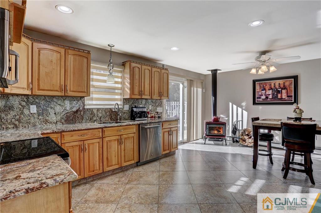 26 Pleasant Valley Road Old Bridge, NJ 08857 - Photo 6 of 25 a kitchen with stainless steel appliances granite countertop a stove top oven a sink dishwasher and cabinets with wooden floor
