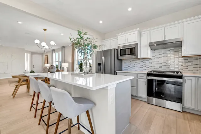a kitchen with kitchen island a large counter top space appliances and cabinets