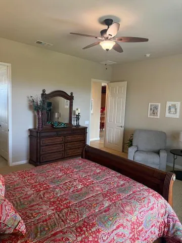 a bedroom with a bed and a dresser