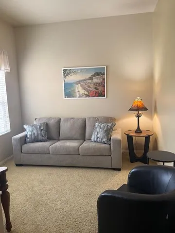 a living room with furniture and a window