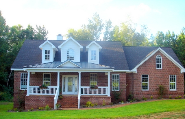 a front view of a house with a yard and porch