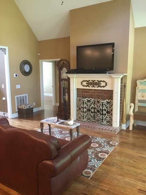 7813 Zebulon Road Macon, GA 31220 - Photo 2 of 21 a living room with fireplace furniture and a flat screen tv