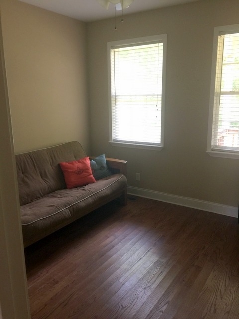 7813 Zebulon Road Macon, GA 31220 - Photo 12 of 21 a living room with a couch wooden floor and a window