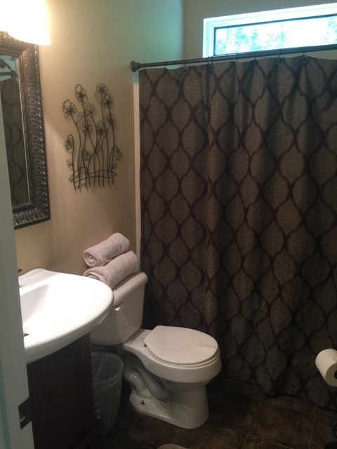 7813 Zebulon Road Macon, GA 31220 - Photo 16 of 21 a white toilet sitting next to a bathroom sink