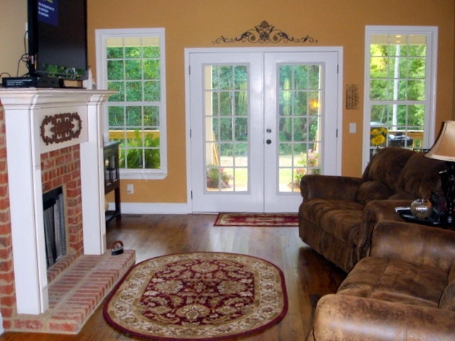 7813 Zebulon Road Macon, GA 31220 - Photo 5 of 21 a living room with furniture and a fireplace