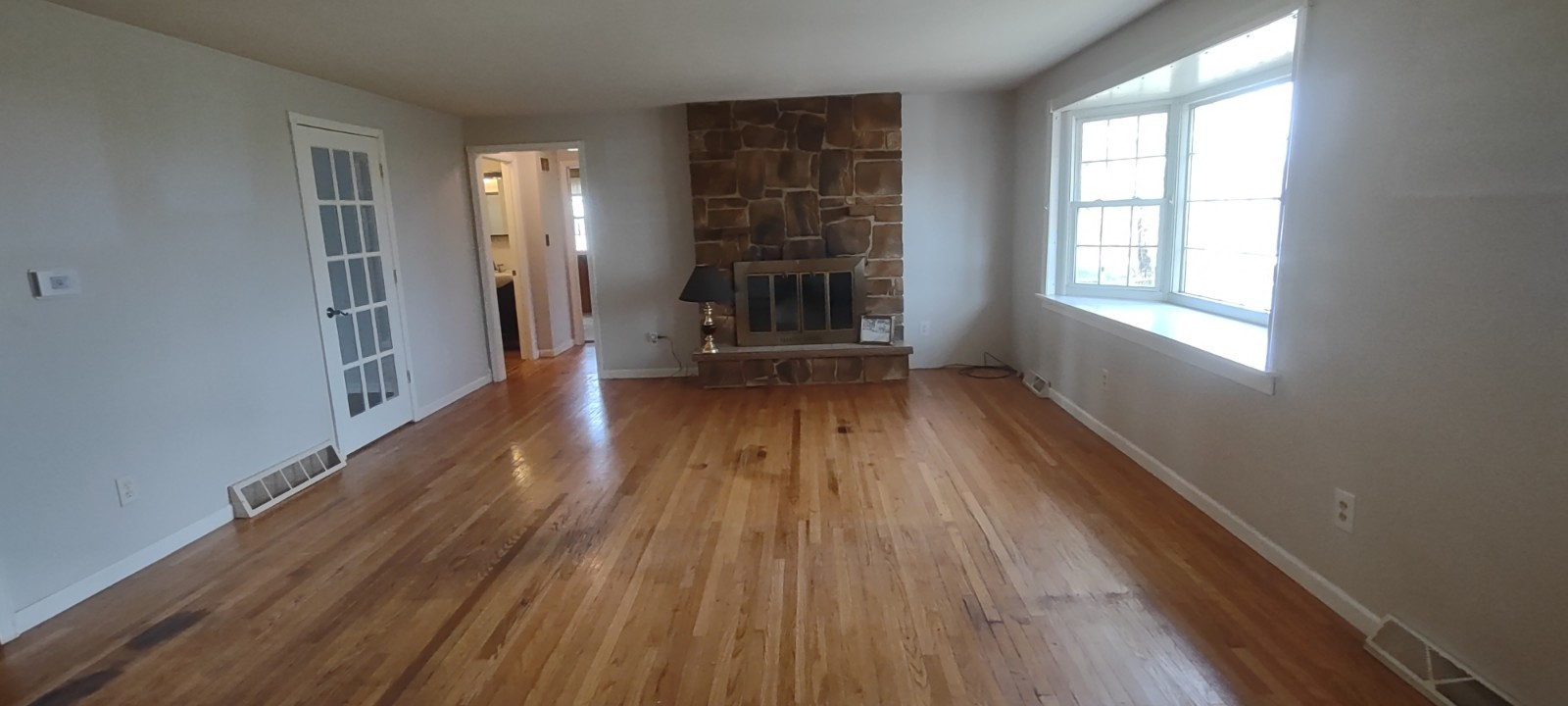 2 Holly Road Sterling, IL 61081 - Photo 5 of 19 wooden floor in an empty room with a window