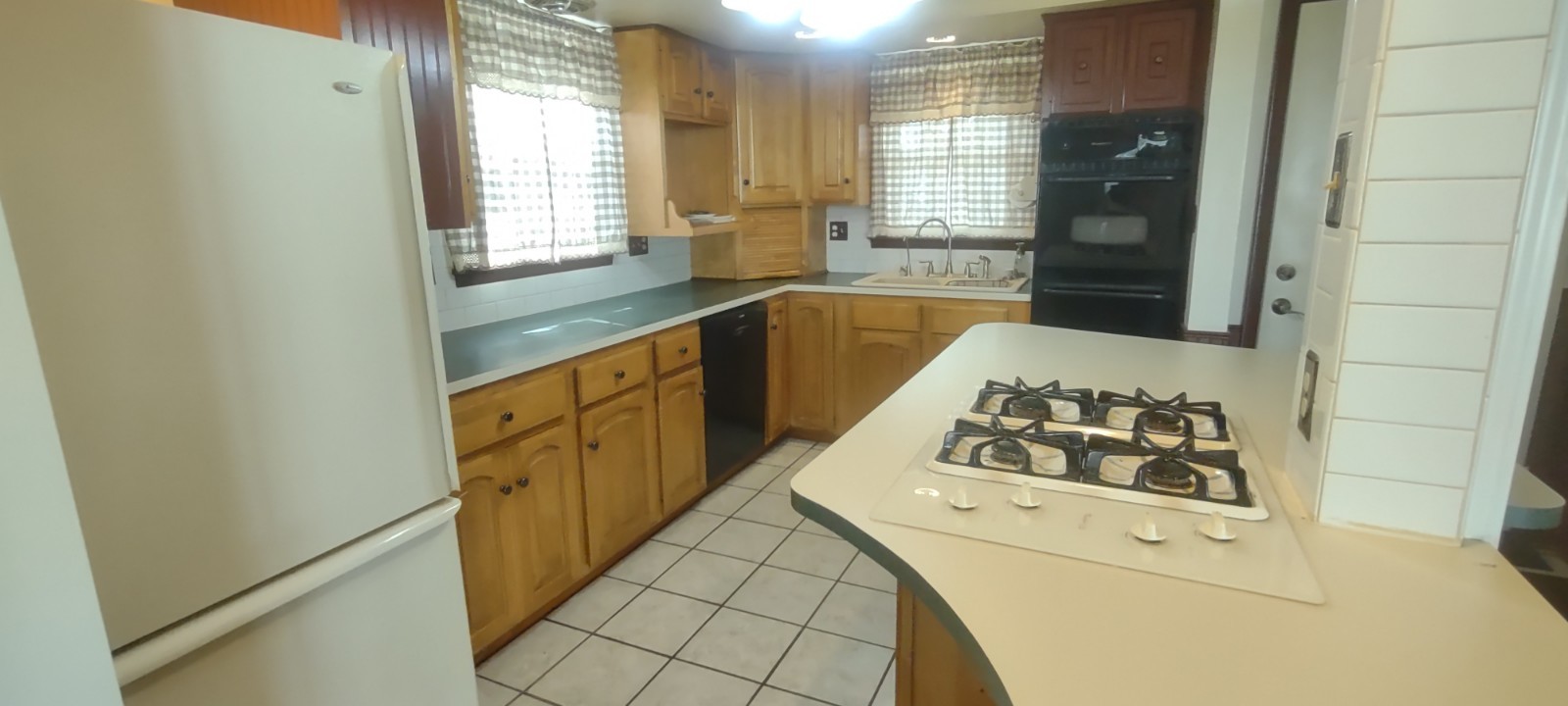 2 Holly Road Sterling, IL 61081 - Photo 7 of 19 a kitchen with a white stove top oven and white countertops with wooden floor
