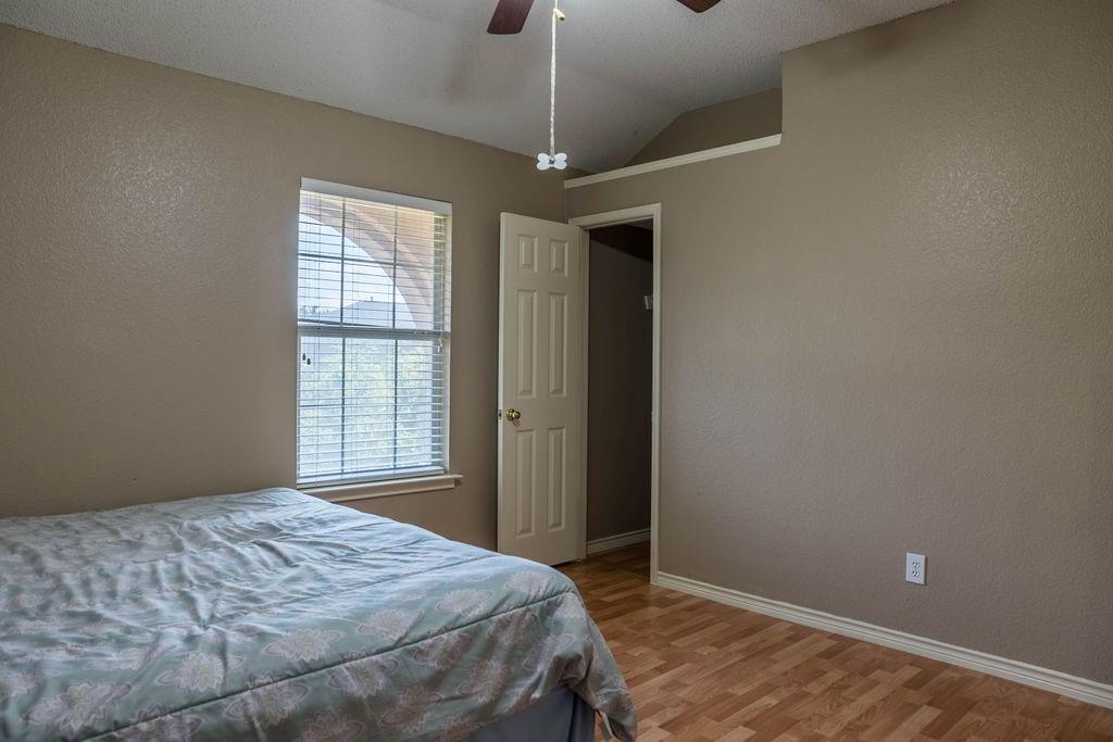4113 Bluffpoint Road Rowlett, TX 75088 - Photo 26 of 39 a bedroom with a bed and a window