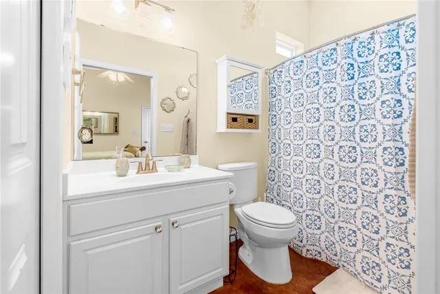 a bathroom with a sink toilet and a mirror