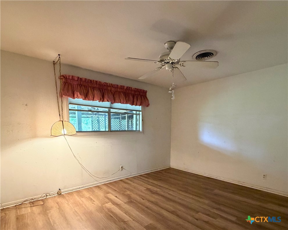 2711 Forest Trail Temple, TX 76502 - Photo 13 of 22 a view of a room with wooden floor and ceiling fan