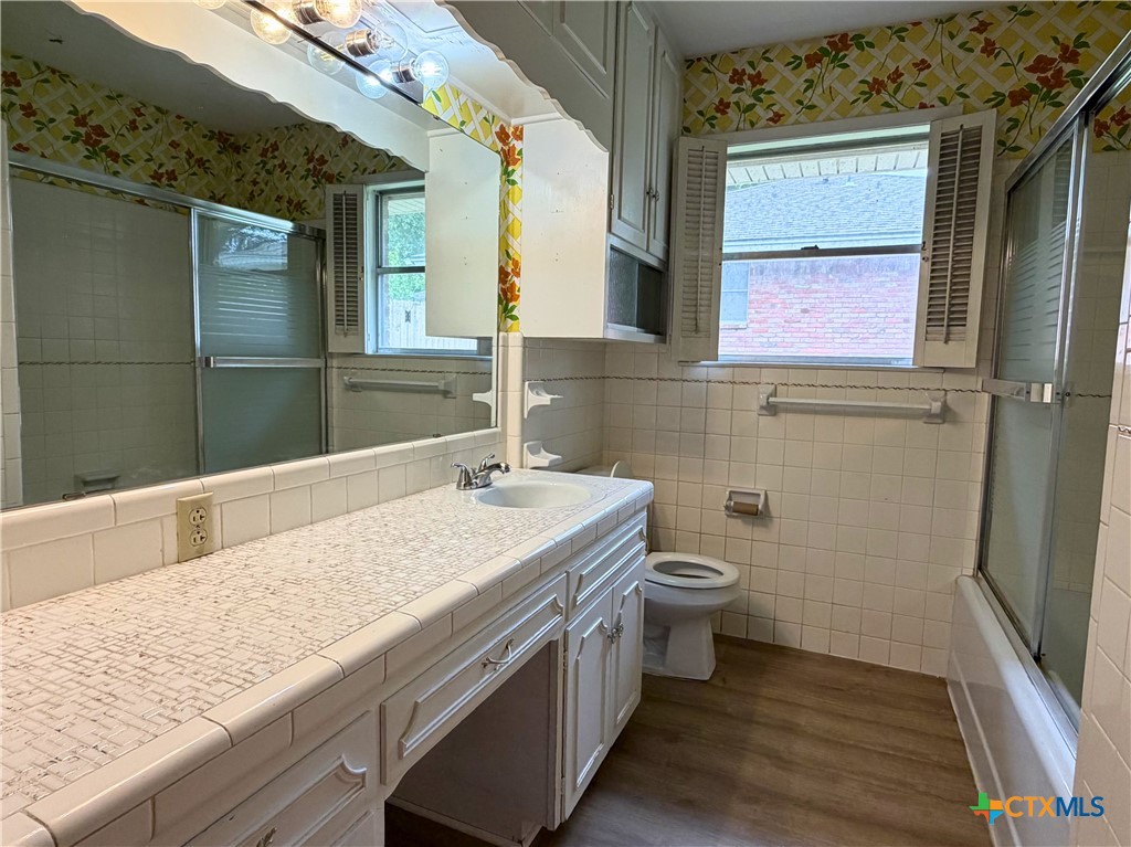 2711 Forest Trail Temple, TX 76502 - Photo 16 of 22 a bathroom with a granite countertop sink toilet and mirror
