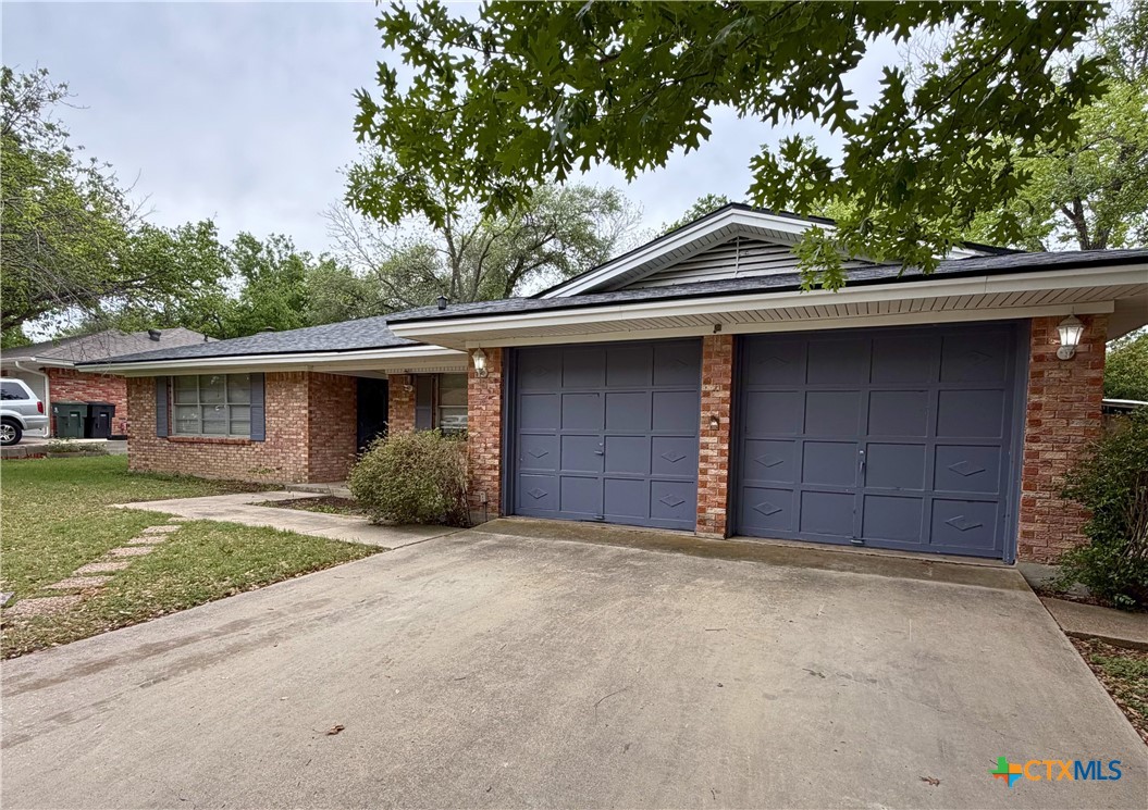 2711 Forest Trail Temple, TX 76502 - Photo 2 of 22 a front view of a house with a yard and garage
