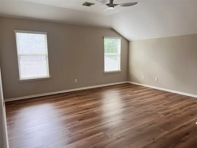 a view of a hallway view with wooden floor and staircase
