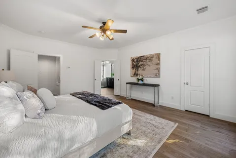 a bedroom with a bed and a chandelier