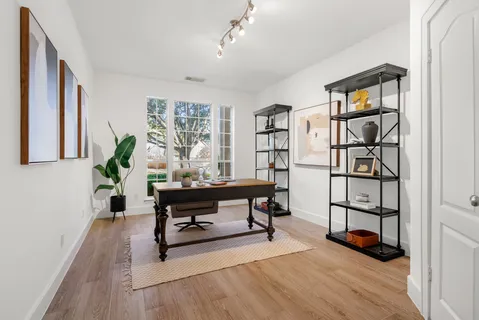a living room with furniture a rug and a window