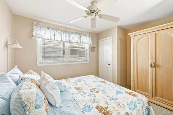 a bedroom with a large bed and a window