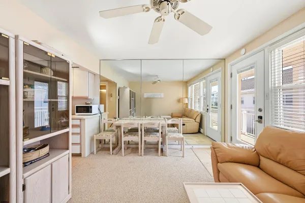a living room with furniture wooden floor and white walls