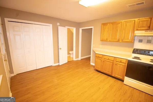 a view of a kitchen with wooden floor and a sink