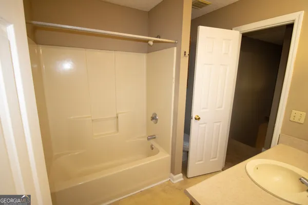 a bathroom with a shower and a toilet