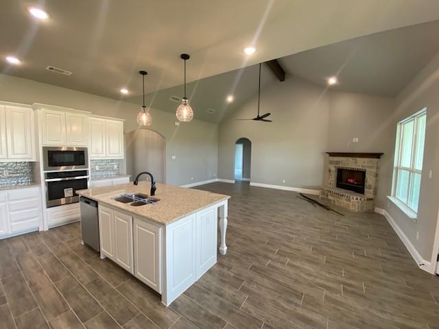 2001 Donna Court Azle, TX 76020 - Photo 9 of 20 a kitchen with stainless steel appliances granite countertop a sink a stove and a wooden floors