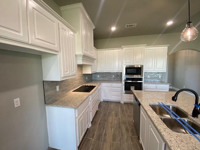 2001 Donna Court Azle, TX 76020 - Photo 10 of 20 a kitchen with granite countertop a stove a sink a refrigerator and cabinets