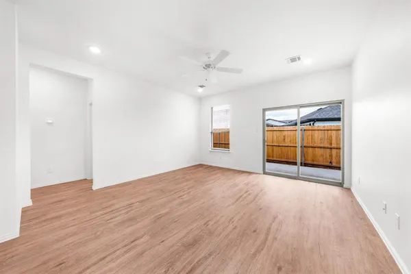 a view of large kitchen with a refrigerator and a sink