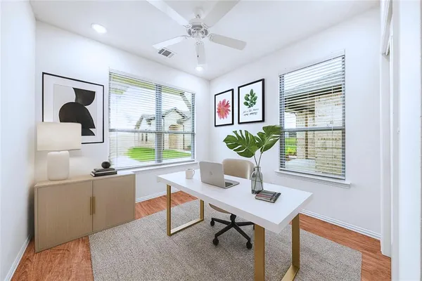 a living room with furniture and a potted plant